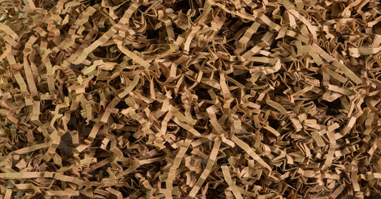 A pile of brown cardboard scraps shredded and folded into thin strips. All the straps are the same shade of brown.
